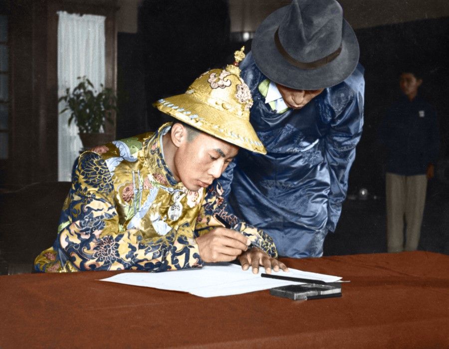 The Dalai Lama signing a document at a Chinese People's Political Consultative Conference (CPPCC) meeting opposing nuclear weapons, December 1954.