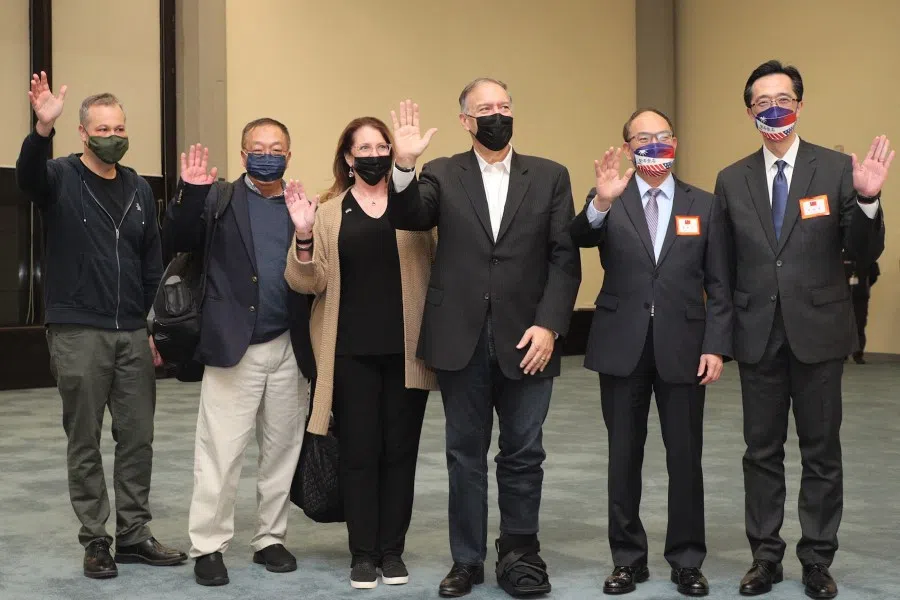This handout picture taken and released by Taiwan's Ministry of Foreign Affairs on 2 March 2022 shows former US Secretary of State Mike Pompeo (third from right), his wife Susan (third from left), and Pompeo's Chinese consultant Miles Yu (second from left) posing for photographs with Taiwan's Deputy Foreign Minister Tseng Hou-jen (second from right) after arriving at the Taoyuan International Airport. (Handout/Taiwan Ministry of Foreign Affairs/AFP)