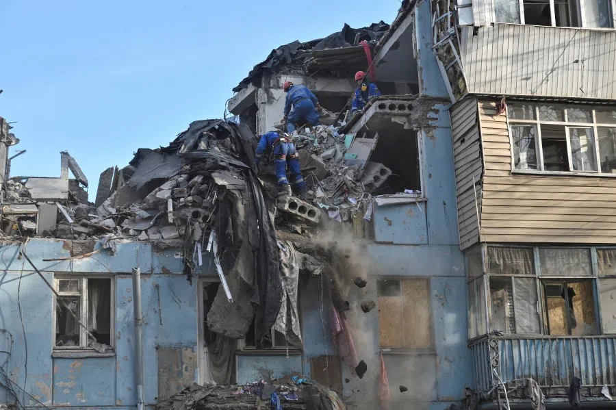 Rescuers work at a site of a residential building heavily damaged by a recent Russian missile strike, amid Russia's attack on Ukraine, in Zaporizhzhia, Ukraine, 4 March 2023. (Stringer/Reuters)