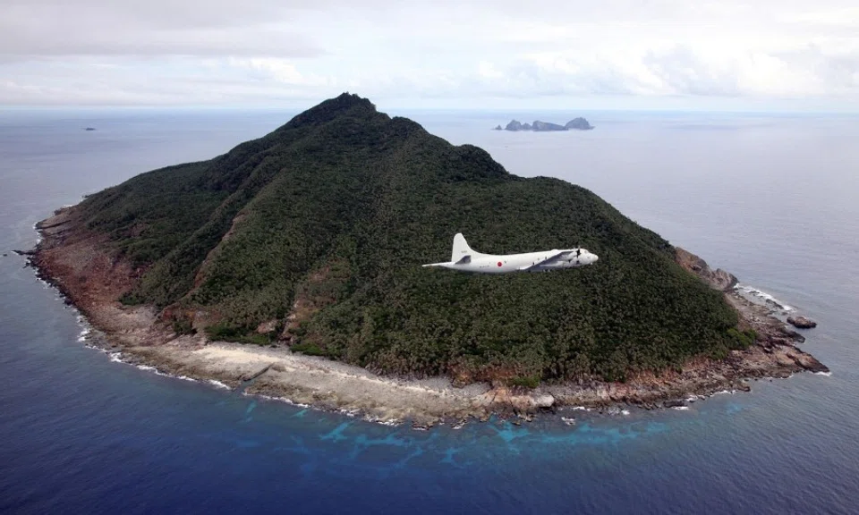 This file photo taken on 13 October 2011 shows a P-3C patrol plane of Japanese Maritime Self-Defense Force flying over the disputed islets known as the Senkaku islands in Japan and Diaoyu islands in China, in the East China Sea. A local assembly of Japan's southern Okinawa island on June 22, 2020 approved a plan to rename the area covering disputed islands in the East China Sea, sparking protests from Beijing and Taipei. (STR/AFP)
