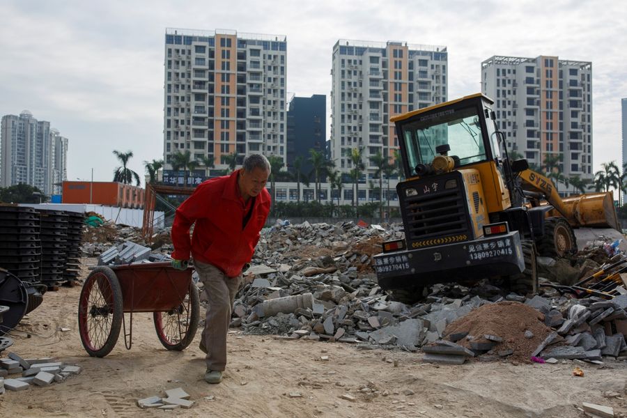 Many people who live in high-end residential districts have already attained or exceeded middle class status in material life, but remain culturally impoverished. This file photo shows a worker pulling a cart at a construction site near new apartment high-rise buildings in the Shekou area of Shenzhen, Guangdong Province, China, on December 13, 2018. (Thomas Peter/File Photo/Reuters)