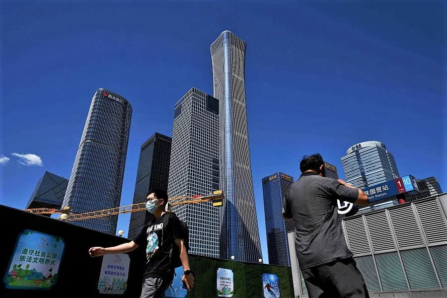 People walk along a street in Beijing, China, on 17 July 2022. (Noel Celis/AFP)