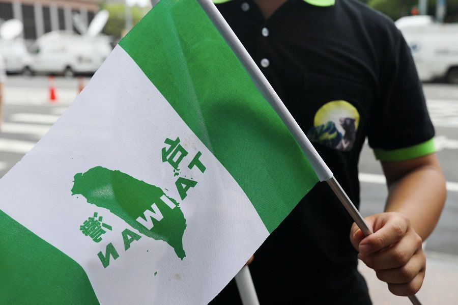 A protester calling for Taiwan independence waves a flag in front of Democratic Progressive Party in Taipei, Taiwan, on 20 May 2020. (Ann Wang/Reuters)