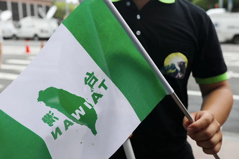 A protester calling for Taiwan independence waves a flag in front of Democratic Progressive Party in Taipei, Taiwan, on 20 May 2020. (Ann Wang/Reuters)