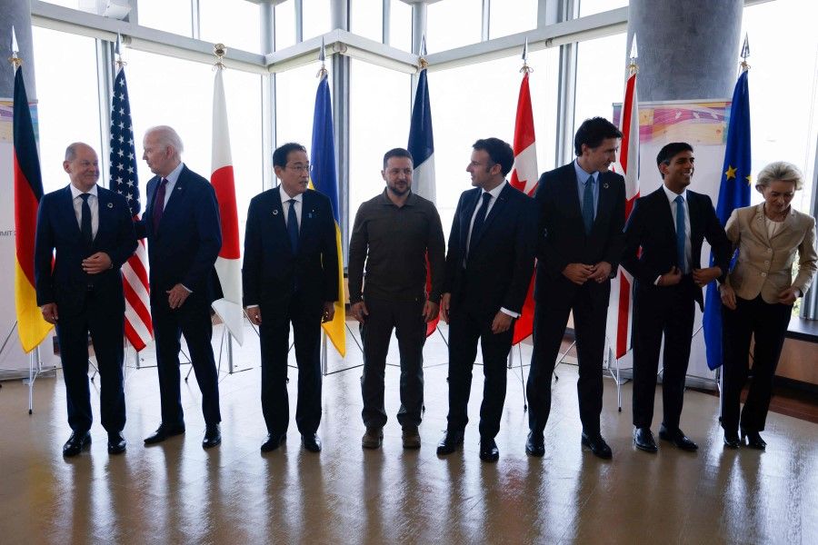 (Left to right) Germany's Chancellor Olaf Scholz, US President Joe Biden, Japan's Prime Minister Fumio Kishida, Ukraine's President Volodymyr Zelensky, France's President Emmanuel Macron, Canada's Prime Minister Justin Trudeau, the UK's Prime Minister Rishi Sunak and European Commission President Ursula von der Leyen pose for a family photo during the G7 Leaders' Summit in Hiroshima on 21 May 2023. (Ludovic Marin/AFP)