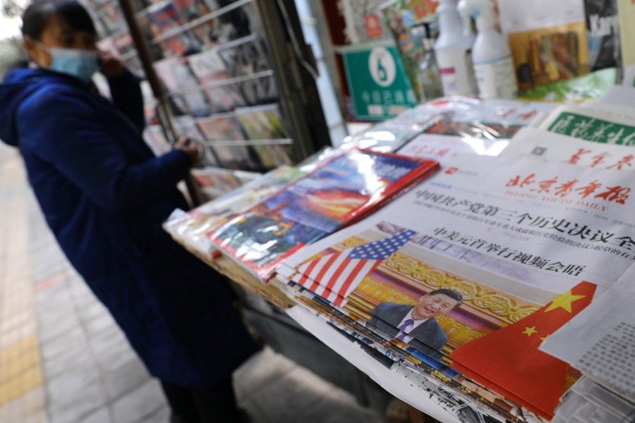 A picture of Chinese President Xi Jinping attending a virtual meeting with US President Joe Biden via video link is seen on a newspaper front-page, at a newsstand in Beijing, China, 17 November 2021. (Tingshu Wang/Reuters)