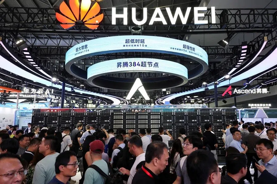 People visit a Huawei booth during the World Artificial Intelligence Conference in Shanghai, China, on 26 July 2025. (Go Nakamura/Reuters)