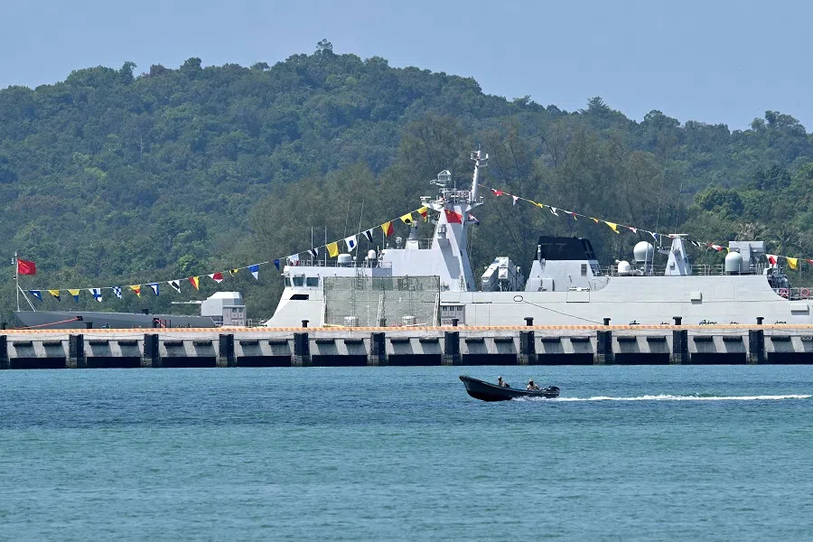 Cambodian soldiers travel on a speedboat near a Chinese warship docked at the Ream Naval Base in Preah Sihanouk province on 5 April 2025. (Tang Chhin Sothy/AFP)