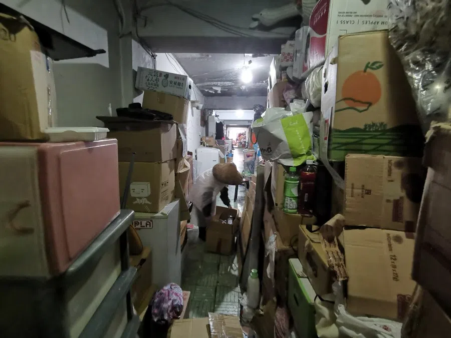 An elderly woman shifts boxes and mutters to herself. (Woon Wei Jong/SPH)