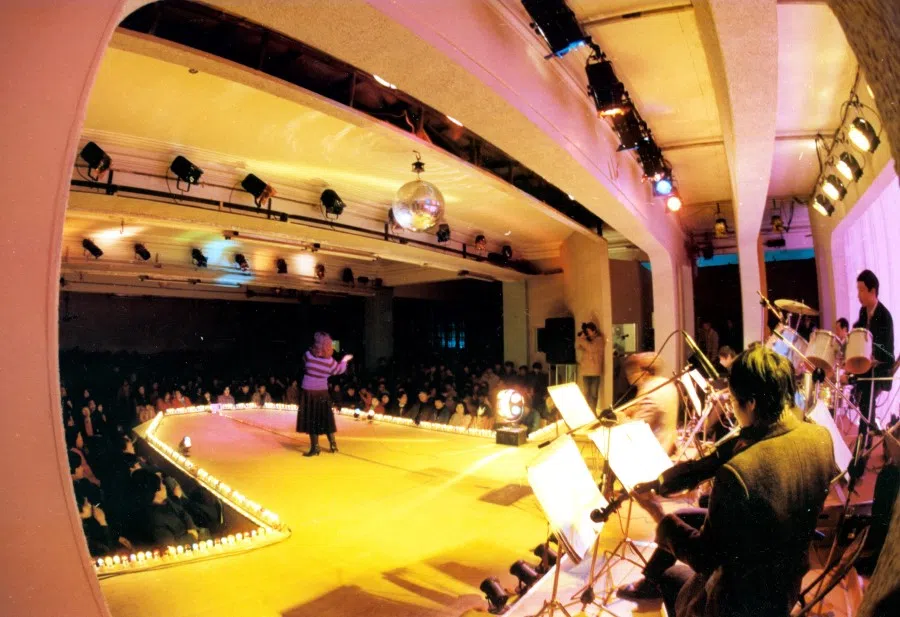 In 1987, the Great World amusement arcade reopened after renovations, attracting a large crowd on its first day. The singer and band on stage evoke the feel of Shanghai at night, harking back to the Great World's golden age of the 1930s. After reform and opening up, Shanghai's traditional consumer industry gradually recovered. Rundown houses were repainted, and fresh new signs were put up as the city sought to regain its former glamour.