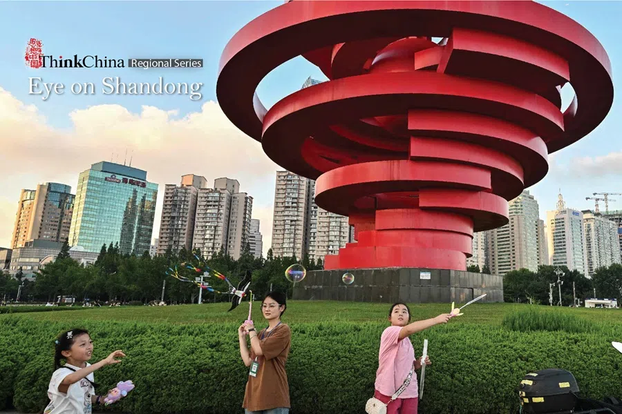People play with soap bubbles at the May Fourth Plaza in Qingdao, China’s eastern Shandong province, on 25 July 2025.
