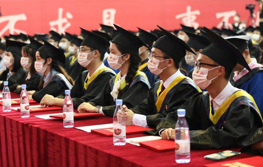 Graduating students wearing face masks attend a commencement ceremony at Chongqing University of Posts and Telecommunications in Chongqing, China, 22 June 2022. (CNS photo via Reuters)