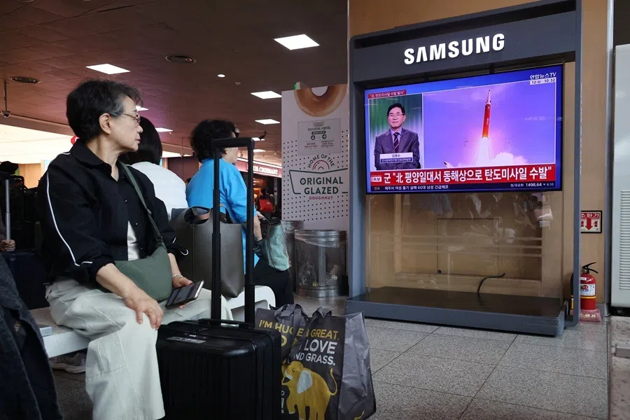 People watch a TV broadcasting a news report on North Korea firing multiple ballistic missiles toward the sea off its east coast, at a railway station in Seoul, South Korea, 12 October 2026.