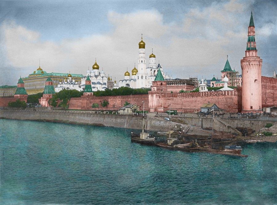 Moscow, Russia, 1890s. On the bank of the Moskva River is the Kremlin, before which are seen huge churches, surrounded by tall steeples and red brick walls.