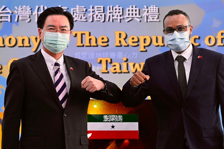 Mohamed Hagi (right), Somaliland's Taiwan representative, bumps elbows while posing with Taiwan's Foreign Minister Joseph Wu during the opening ceremony of the Somaliland representative office in Taipei on 9 September 2020. (Sam Yeh/AFP)