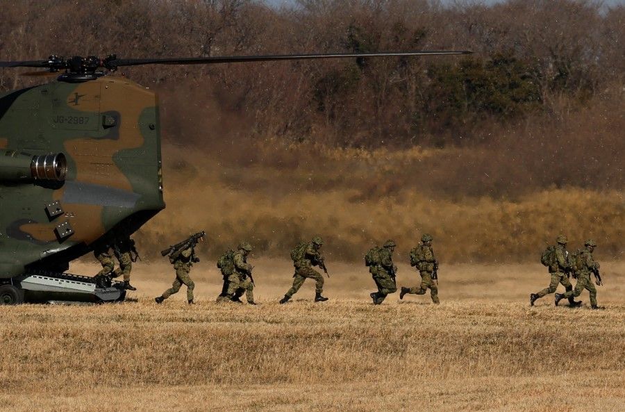 Members of the Japan Ground Self-Defense Force (JGSDF) 1st Airborne Brigade take part in a new year joint military drill among Japan, the US, Britain and Australia at Narashino exercise field in Funabashi, east of Tokyo, Japan, 8 January 2023. (Issei Kato/Reuters)
