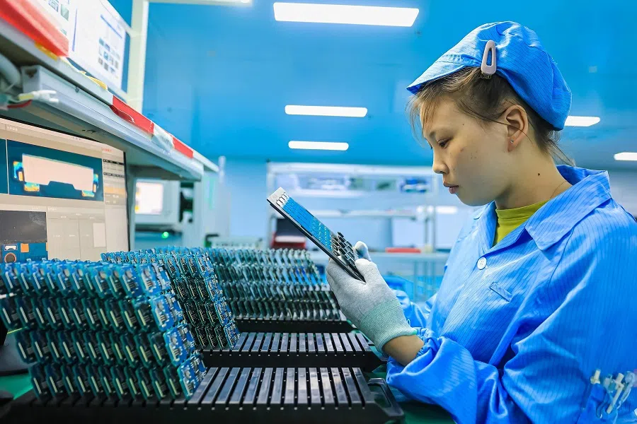 An employee produces components for a new energy vehicle at a factory in Ruichang, in southeastern China's Jiangxi province on 19 September 2023. (AFP)