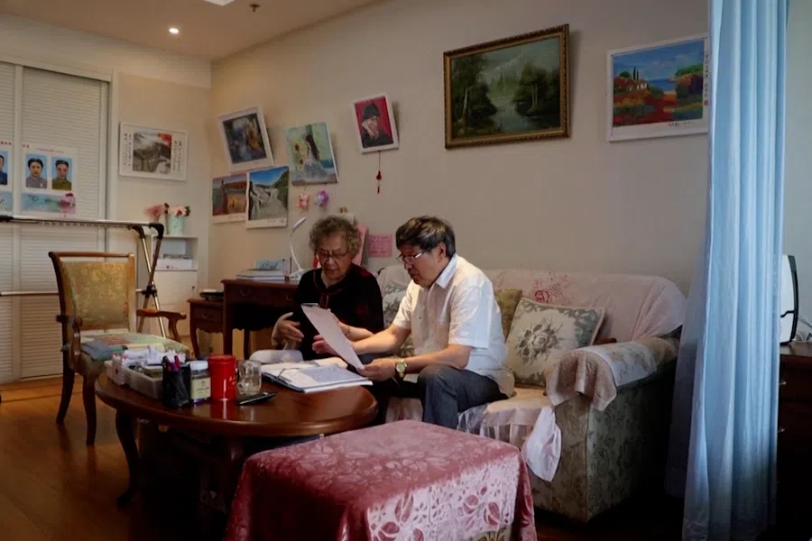 Elderly couple sings together in their room at Heyuejia retirement home in Beijing, China. (Screen grab from Reuters)