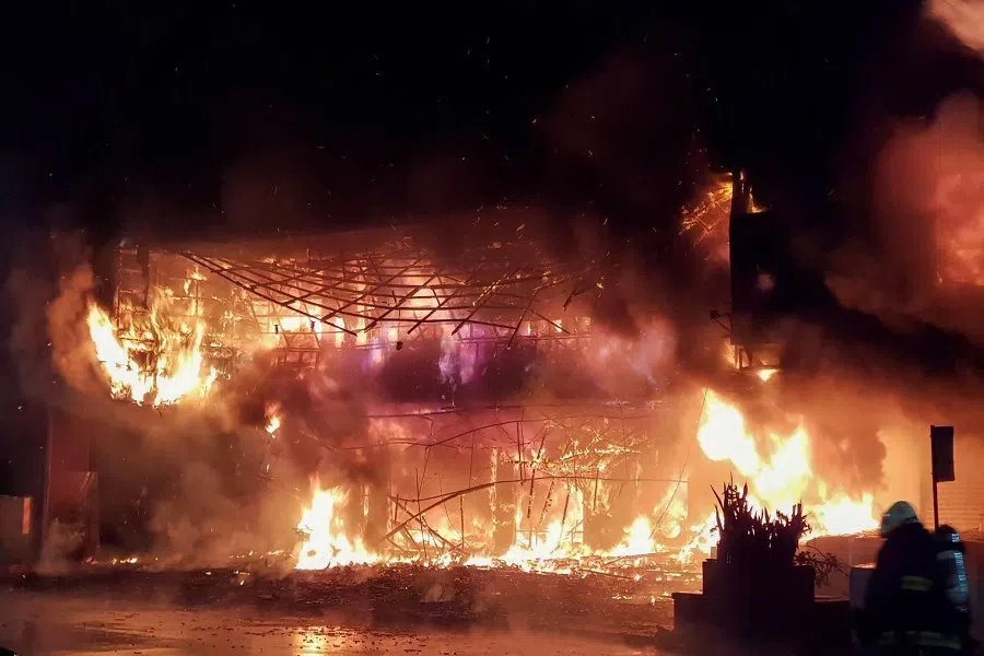 This handout photo released by the Kaohsiung Fire Department on 14 October 2021 shows firefighters battling an overnight blaze that tore through the Cheng Chung Cheng Building in the southern Taiwanese city of Kaohsiung, killing at least 46 people and injuring dozens of others. (Handout/Kaohsiung Fire Department/AFP)