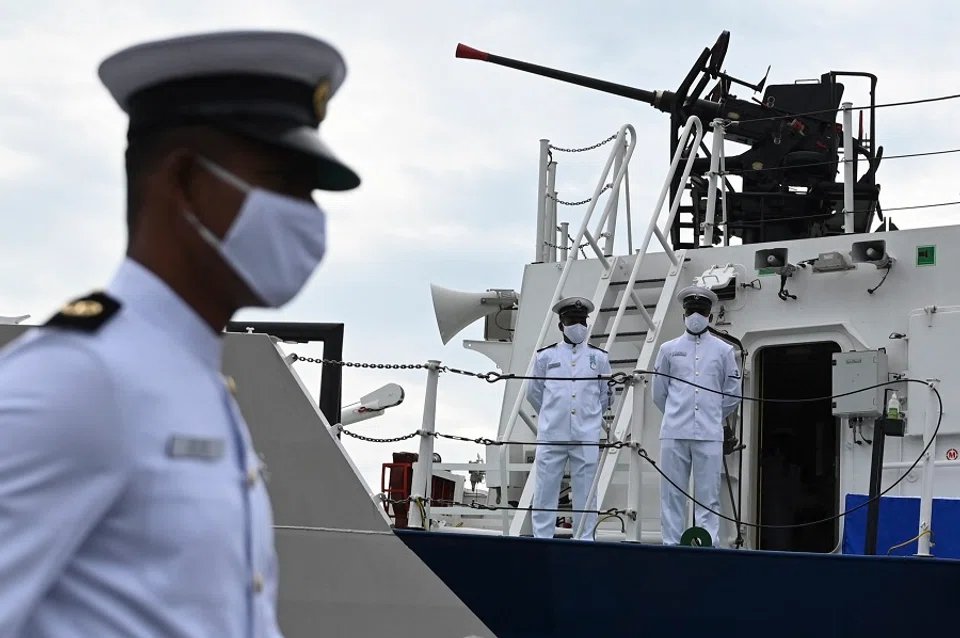 Coast guard officers stand on the deck of the Indian Coast Guard offshore patrol vessel 'VIGRAHA' during its commissioning ceremony, in Chennai, India, on 28 August 2021. (Indian Navy/AFP)