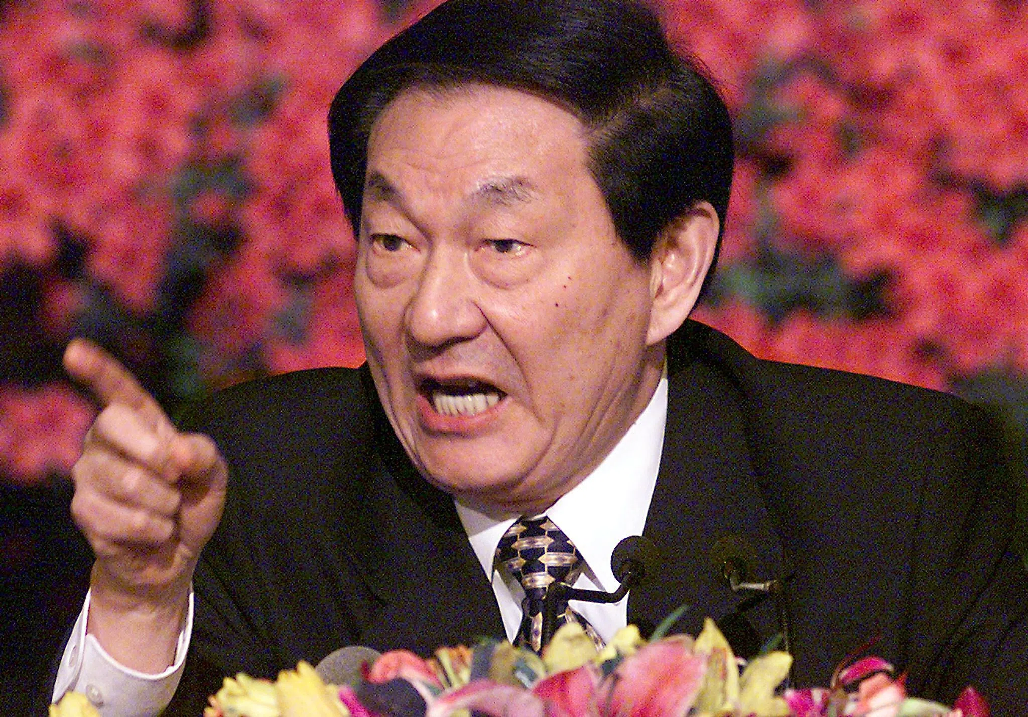 Chinese Premier Zhu Rongji responds to a journalist's question during a press conference after the closing session of the National People's Congress, on 15 March 2000, in Beijing.