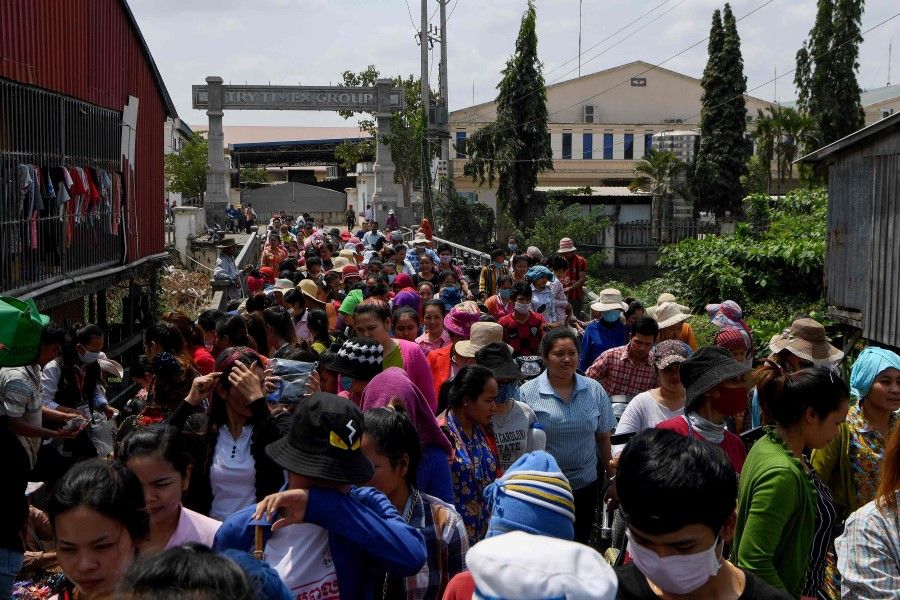 Cambodian workers exit their factory as they take a lunch break in Phnom Penh, March 2, 2020. Cambodia's multi-billion-dollar garment industry is at risk of chain disruption from the Covid-19 breakout, as its impacts hammer on Southeast Asia's key industries. (Tang Chhin Sothy/AFP)