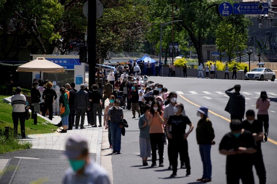 Residents line up for PCR tests on a street as the city prepares to end the lockdown placed to curb the Covid-19 outbreak in Shanghai, China, 31 May 2022. (Aly Song/Reuters)