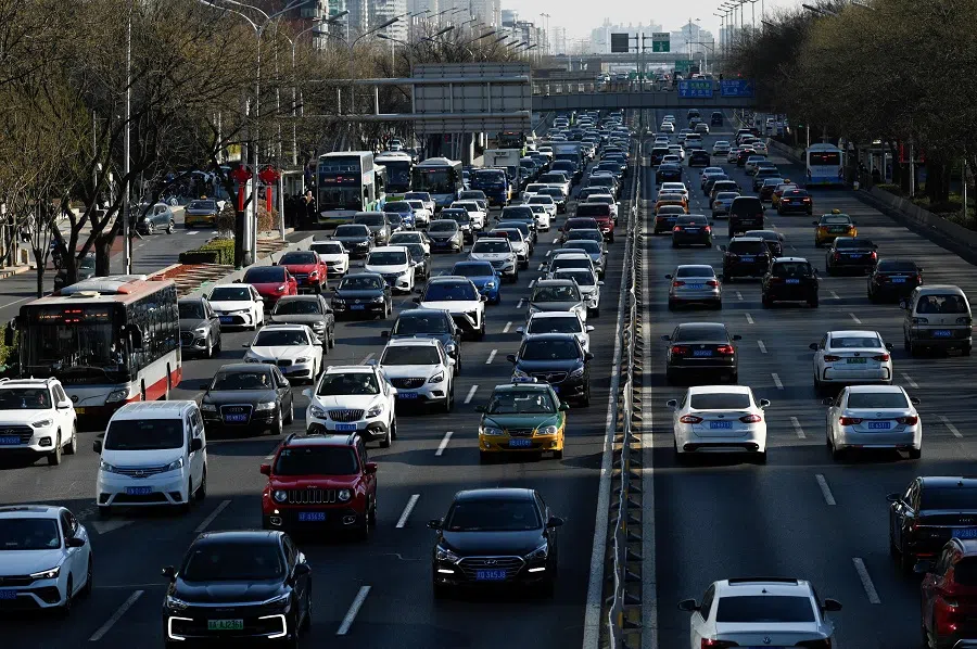 Vehicles drive along a street at the central business district in Beijing, China, on 16 January 2023. (Wang Zhao/AFP)