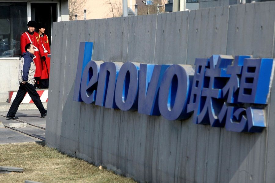 A pedestrian walks past a Lenovo logo in Beijing, China, 4 February 2010. (Jason Lee/File Photo/Reuters)