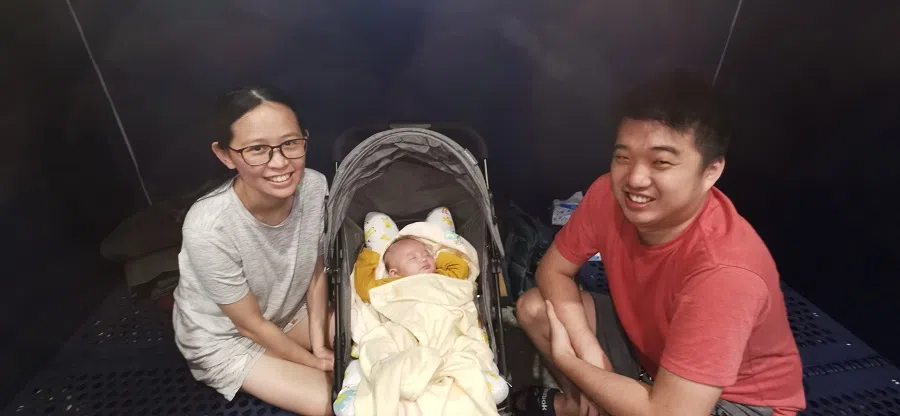 Hendri Sutrisno, seen pictured with his wife and daughter, at a disaster relief shelter.