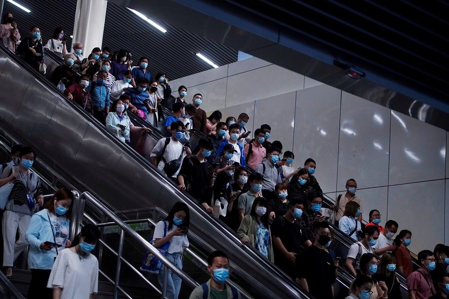 People walk at a subway station in Shanghai, China, 11 May 2021. (Aly Song/Reuters)