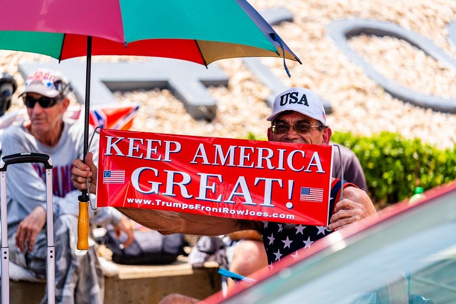 A person holds a sign that reads "Keep America Great!" outside of the BOK Center ahead of a rally for US President Donald Trump in Tulsa, Oklahoma, US, on 17 June 2020. (Christopher Creese/Bloomberg)