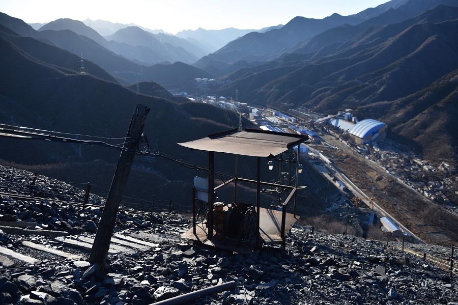 In this file photo taken on 11 December 2019, mining equipment on a mountain of rocks above the Datai coal mine in Mentougou, west of Beijing, is seen. China is closing more of its coal mines to cut carbon emissions and switch to renewables. (Greg Baker/AFP)