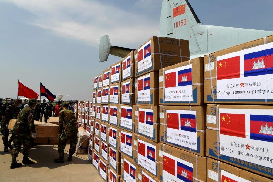 Cambodian soldiers carry aid including medical equipment from China, to be used to combat the spread of the COVID-19 coronavirus, at Phnom Penh International Airport in Phnom Penh, 25 April 2020. (Tang Chhin Sothy/AFP)