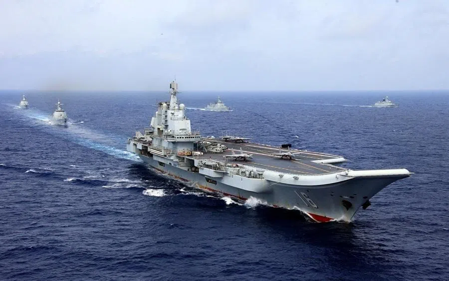 FILE PHOTO: China's aircraft carrier Liaoning takes part in a military drill of Chinese People's Liberation Army (PLA) Navy in the western Pacific Ocean, April 18, 2018. Picture taken April 18, 2018. REUTERS/Stringer ATTENTION EDITORS - THIS IMAGE WAS PROVIDED BY A THIRD PARTY. CHINA OUT./File Photo
