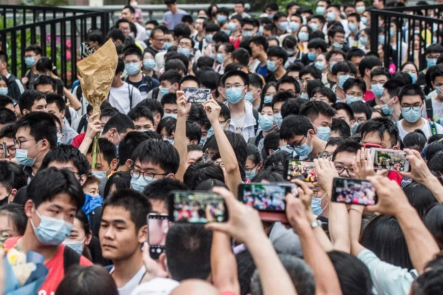 This photo taken on 9 June 2021 shows students leaving a school after finishing the National College Entrance Examination (NCEE) in Wuhan, Hubei province. (STR/AFP)