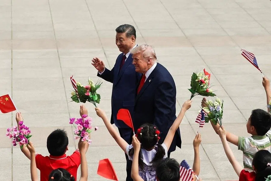 Children hold Chinese and US flags, as US President Donald Trump participates in a welcome ceremony with Chinese President Xi Jinping at the Great Hall of the People in Beijing, China, on 14 May 2026. (Maxim Shemetov/Pool/Reuters)