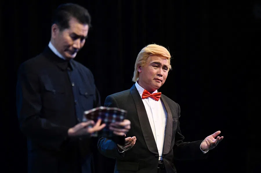 This photo taken on 31 January 2025 shows Hong Kong actor Loong Koon-tin made up as US President Donald Trump (right) on stage during a rehearsal of the satirical play Trump On Show, which was performed in the Sunbeam Theatre in Hong Kong. (Peter Parks/AFP)