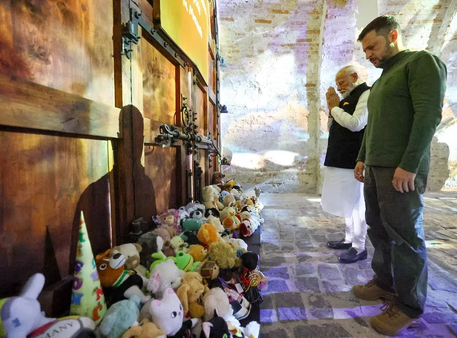 India’s Prime Minister Narendra Modi and Ukraine’s President Volodymyr Zelenskiy pay their respects to the children killed amid Russia’s attack on Ukraine, at Martyrologist Exposition in Kyiv, Ukraine, on 23 August 2024. (India’s Press Information Bureau/Handout via Reuters)