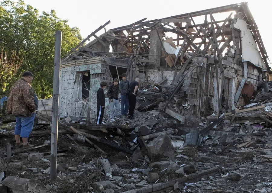 Residents inspect a private house damaged by Russian drone strikes, amid Russia's attack on Ukraine, in Dnipro, Ukraine, 9 September 2026.