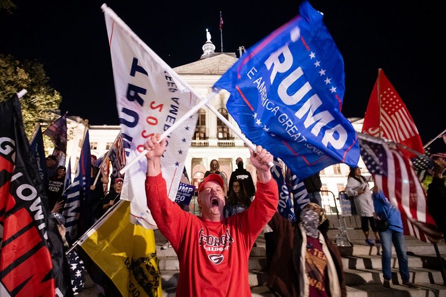 A supporter of President Donald Trump yells at counter-protesters across the street during a rally to protest against the election results outside the Georgia State Capitol on 14 November 2020 in Atlanta, Georgia. (Elijah Nouvelage/Getty Images/AFP)