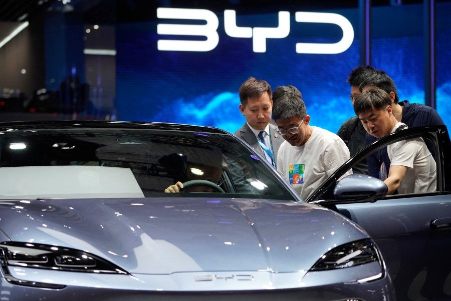 Visitors look at a BYD Seal electric vehicle at the Auto Shanghai show, in Shanghai, China, 18 April 2023. REUTERS/Aly Song
