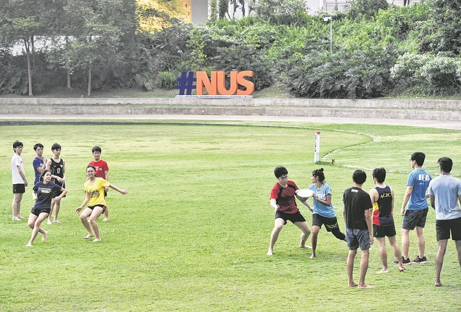 Students play frisbee at the National University of Singapore, 23 October 2020. (SPH Media)