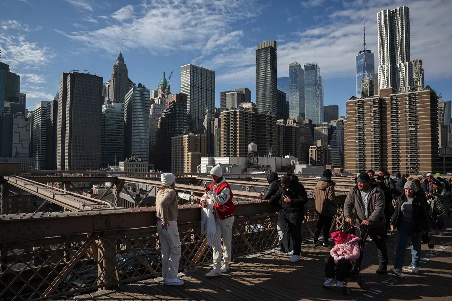 People walk along the Brooklyn Bridge in Manhattan in New York City, US, on 26 December 2024. (Marko Djurica/Reuters)
