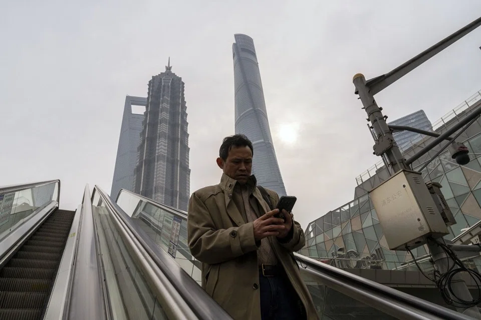 A pedestrian rides an escalator in Pudong's Lujiazui Financial District in Shanghai, China, on 29 January 2024. (Raul Ariano/Bloomberg)