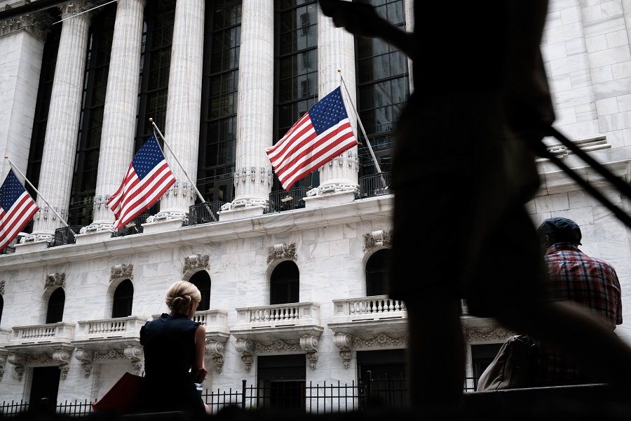 People walk by the New York Stock Exchange (NYSE) on 16 September 2021 in New York City, US. (Spencer Platt/Getty Images/AFP)