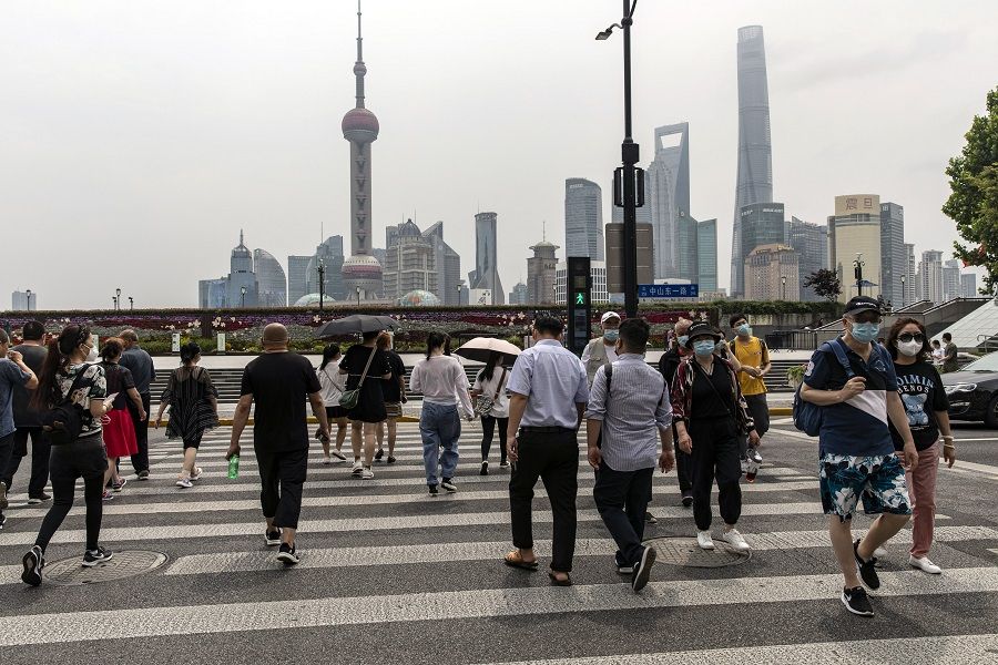 Pedestrians near the Bund in Shanghai, China, on 1 June 2022. (Qilai Shen/Bloomberg)