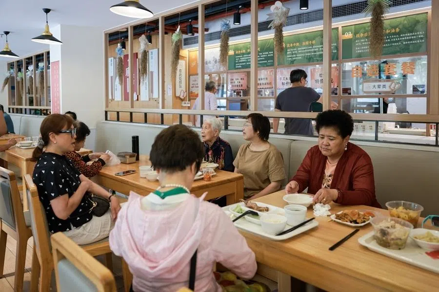 The elderly and members of the public buying food and eat their meals at the Renshoutang Xianxia Senior Canteen in Shanghai on 6 June 2025.