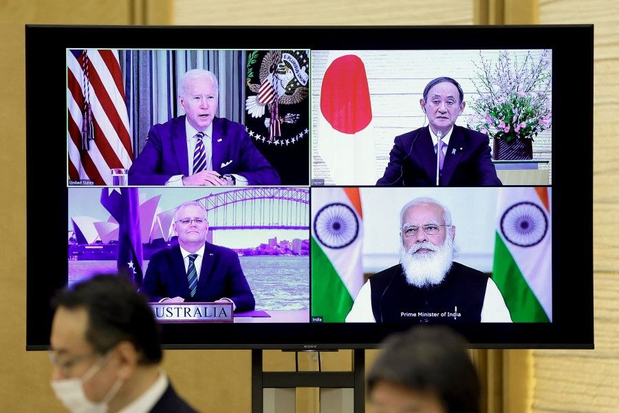 A monitor displaying the virtual meeting of US President Joe Biden (top left), Australia's Prime Minister Scott Morrison (bottom left), Japan's Prime Minister Yoshihide Suga (top right) and India's Prime Minister Narendra Modi is seen during the virtual Quadrilateral Security Dialogue (Quad) meeting at Suga's official residence in Tokyo on 12 March 2021. (Kiyoshi Ota/AFP)