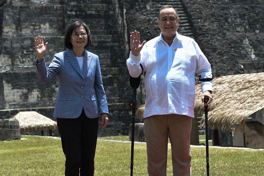 This handout picture released by the Guatemalan Presidency shows Taiwan's President Tsai Ing-wen (left) and Guatemala's President Alejandro Giammattei posing for a picture at the Tikal archaeological site in Peten, Guatemala on 1 April 2023. (Handout/Guatemalan Presidency/AFP)